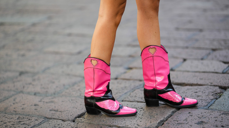 woman wearing pink cowboy boots