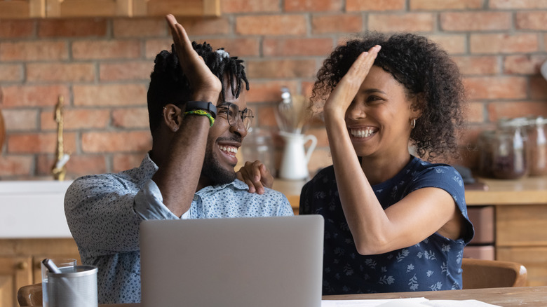 couple high-fiving each other