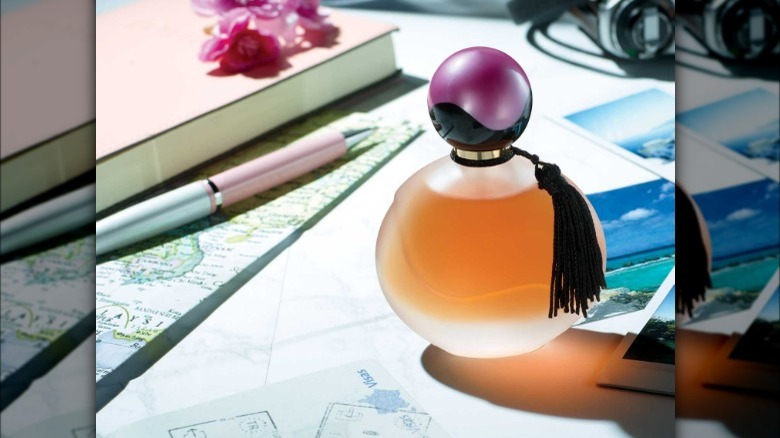 Fragrance bottle on cluttered table