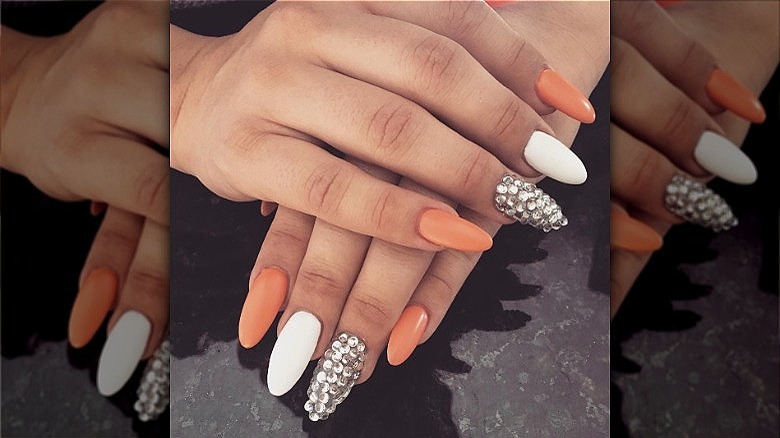 woman with matte creamsicle nails