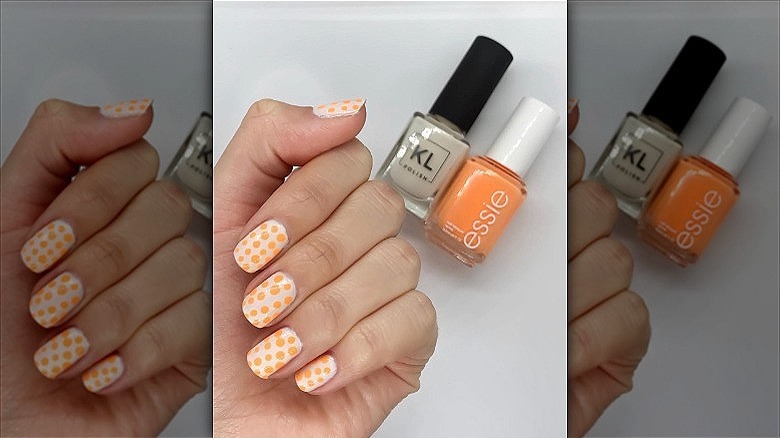 woman with polka dot creamsicle nails