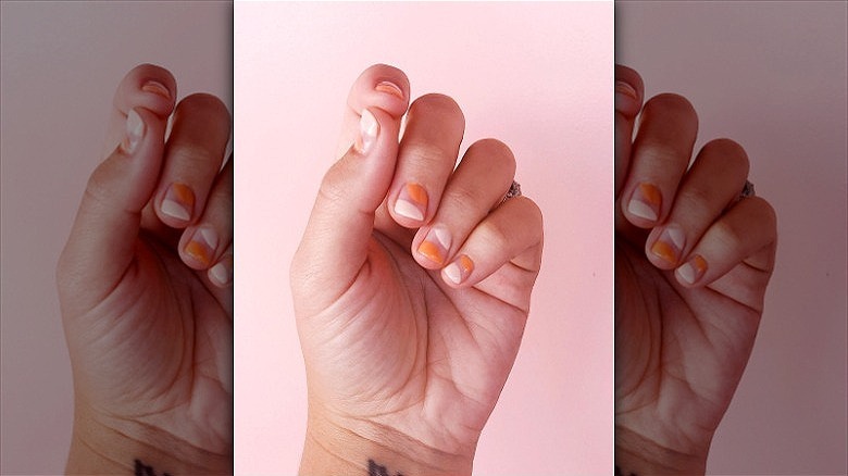 woman with pink and creamsicle nails