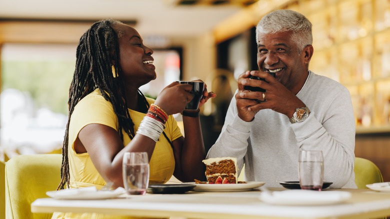 Couple drinks coffee and eats cake