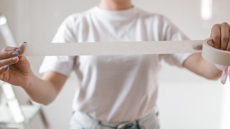 Woman holding a roll of tape