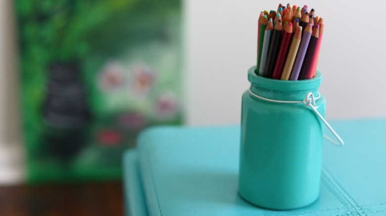 Colored pencils in teal jar