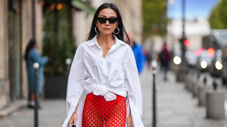 Woman walking in tied white button-up