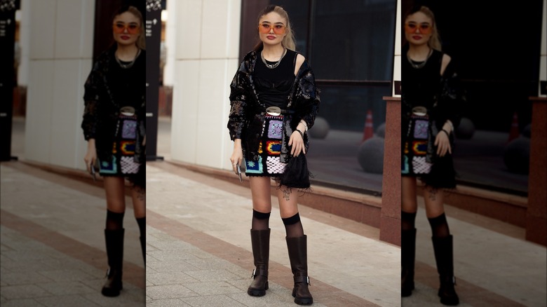 A woman in a patchwork crochet mini skirt