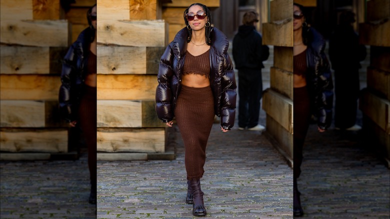 A woman in a brown crochet skirt and top set