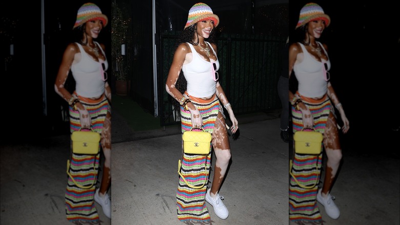 Winnie Harlow in a maxi crochet skirt with a slit