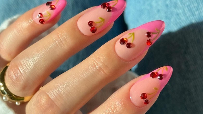 woman with rhinestone cherry nails