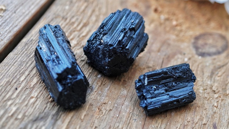 Chunks of black tourmaline on wood