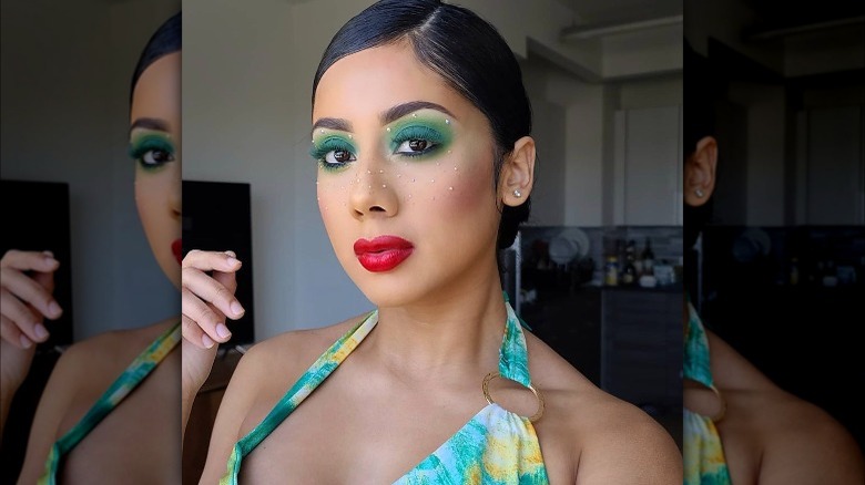 A woman with green eye makeup