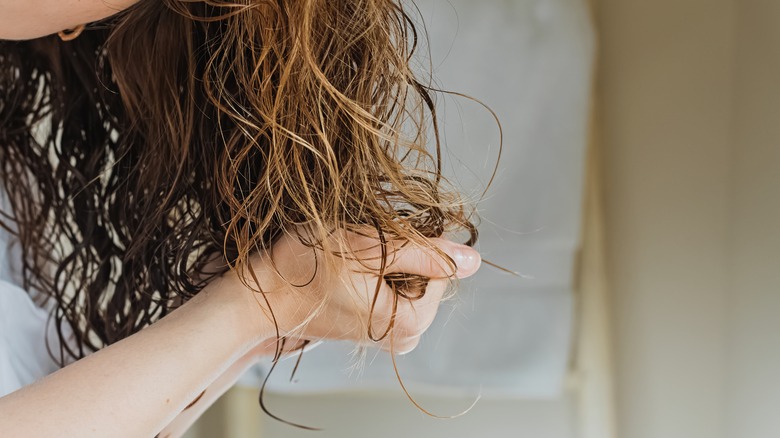 Woman scrunching curly hair