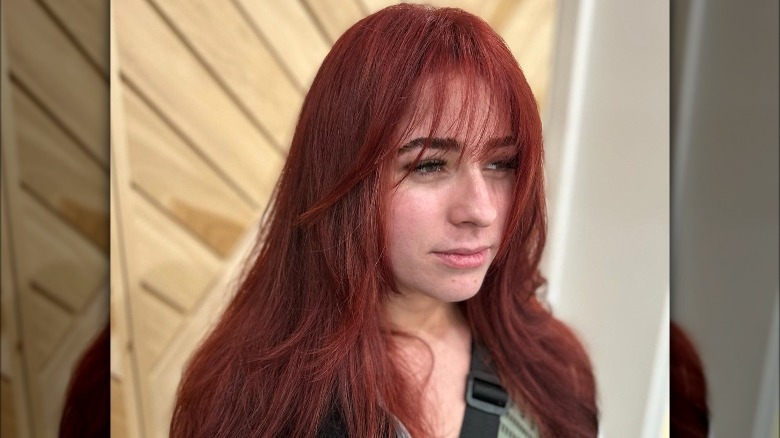 Woman with red hair and bangs