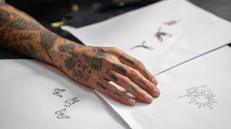 lettering tattoo on fingers