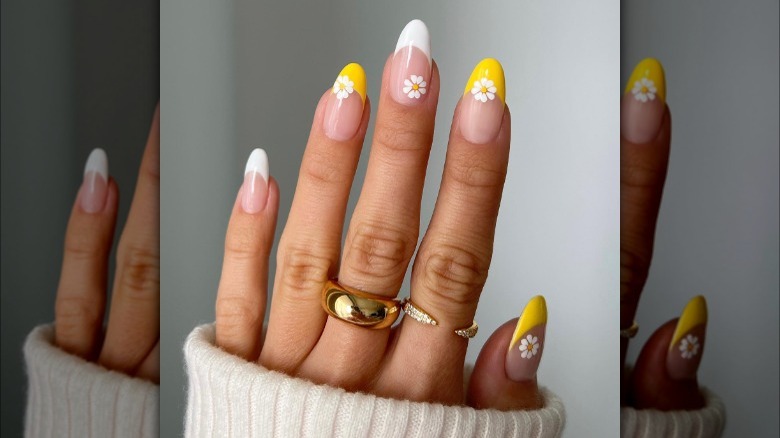 Yellow French tip daisy manicure