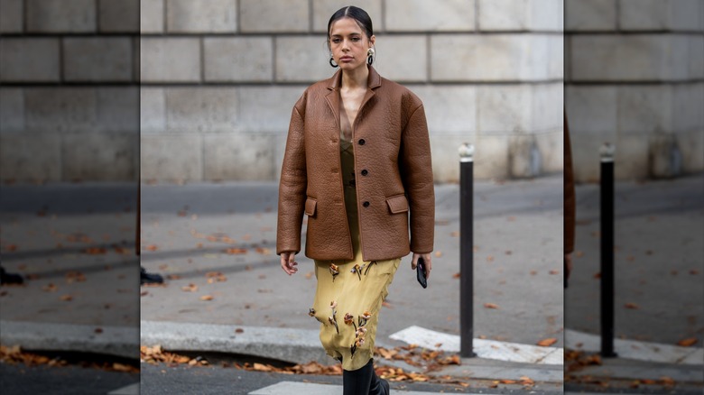 Woman wearing floral dress, leather jacket