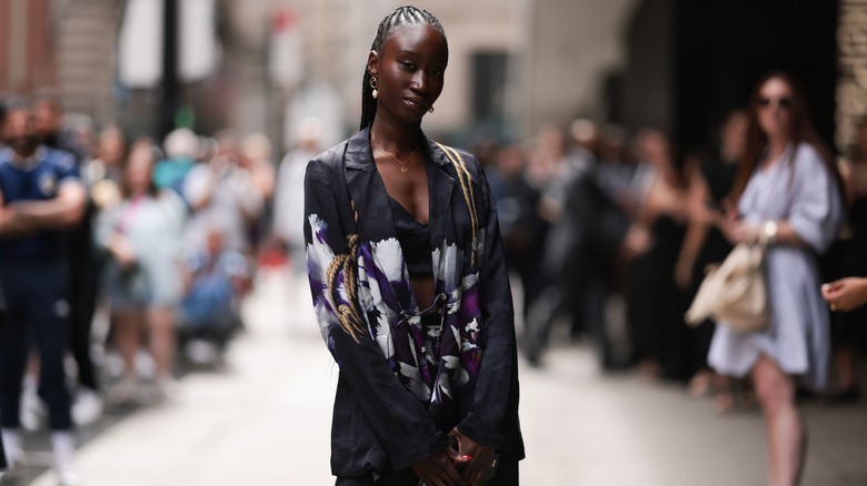 Woman wearing black floral blazer