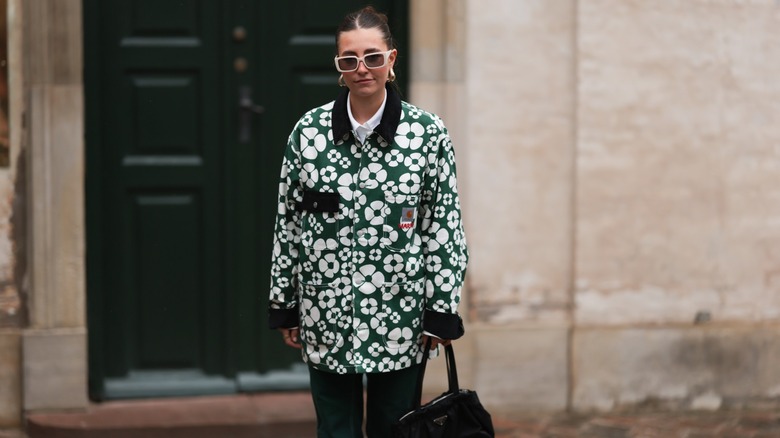 Woman wearing green floral jacket
