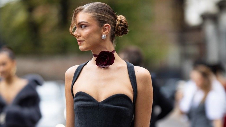 Woman wearing bergundy rosette necklace