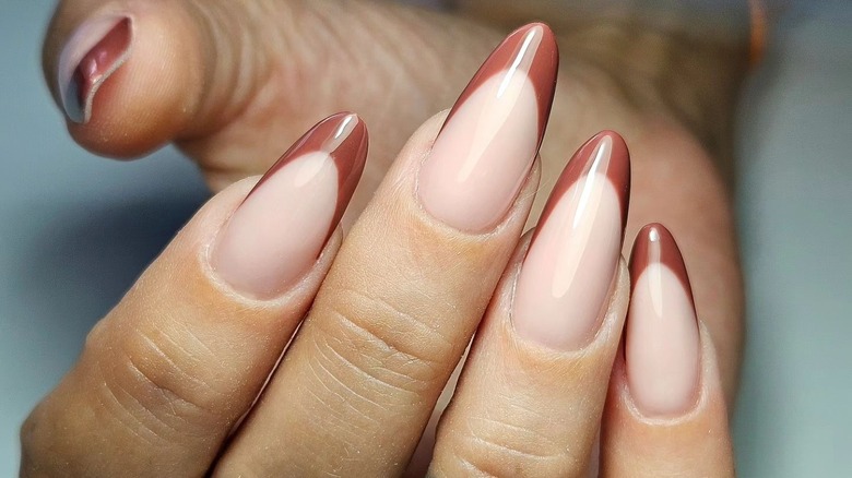 Hand showing brown French manicure