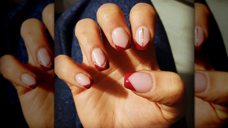 Hand with red French manicure