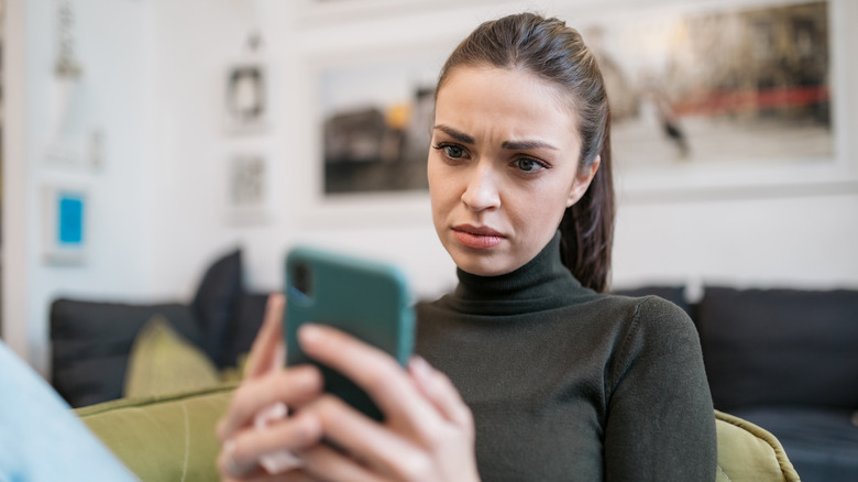 Woman looking intensely at phone