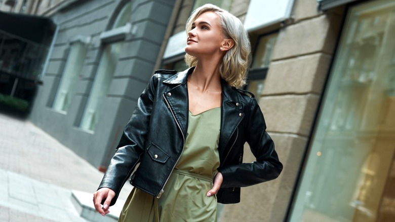 Woman wearing leather jacket over romper