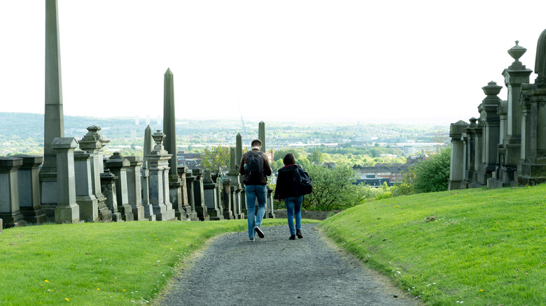 couple walking through cemetery