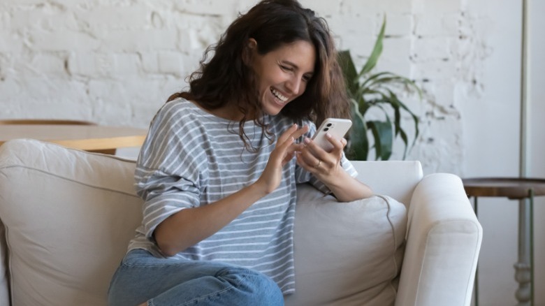 Woman laughing at her phone