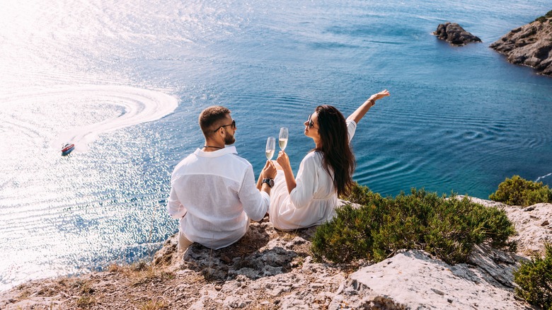 Couple drinking champagne at beach 