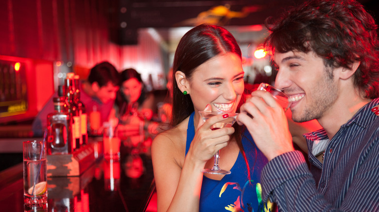 Couple at bar drinking