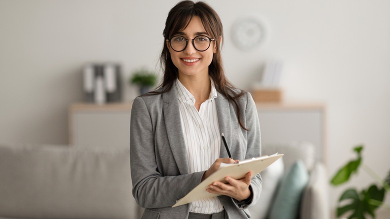 bespectacled therapist smiling 