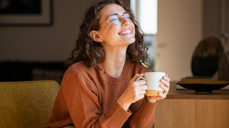 woman smiling drinking coffee