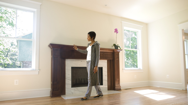 woman touching fireplace