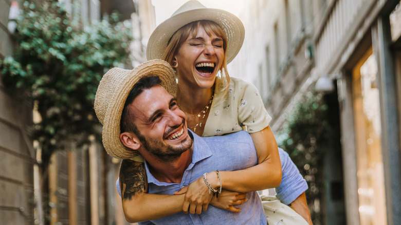 Man giving woman a piggyback ride