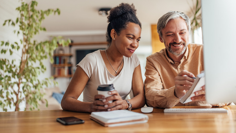 Couple making list on notepad