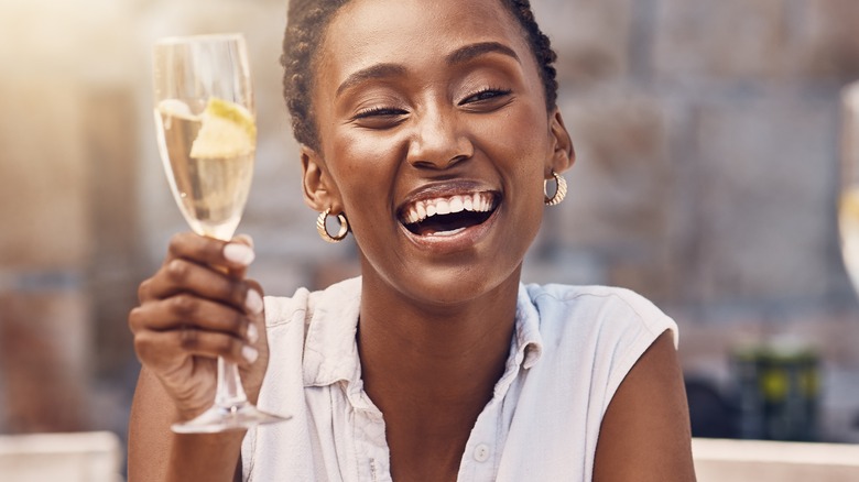 a woman drinks champagne