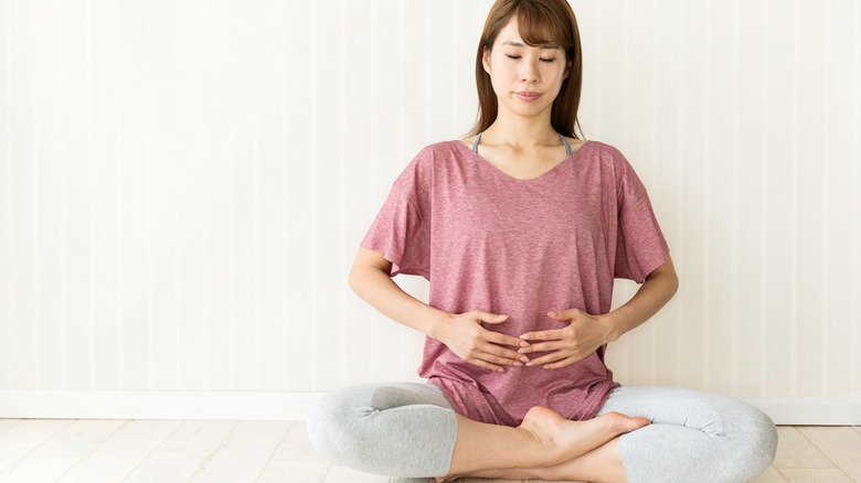 woman holding stomach