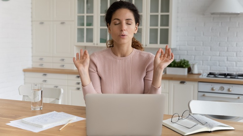 woman with eyes closed breathing