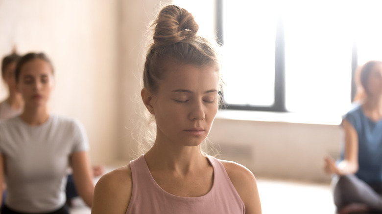 woman sitting in yoga class