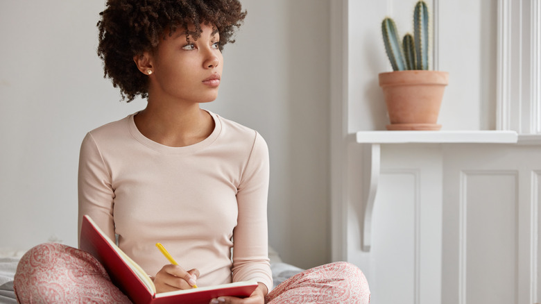 Woman writing in journal