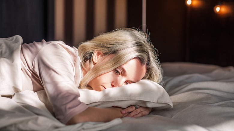 Sad woman in bed