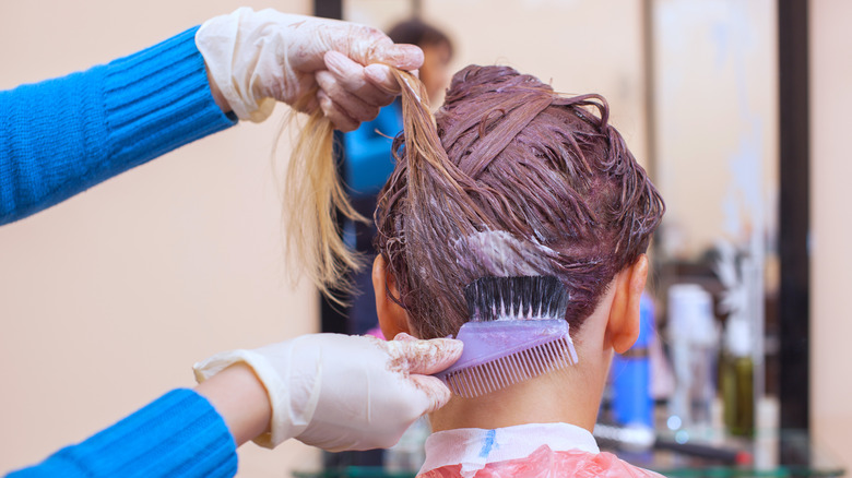 person dyeing hair purple