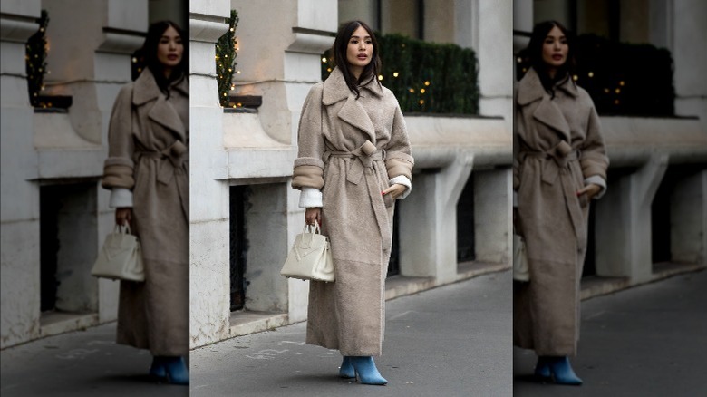 Woman in coat, denim boots