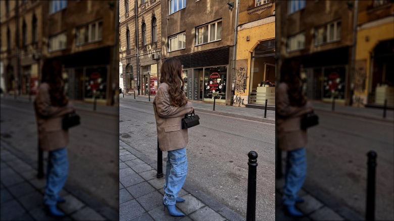 Woman wearing slouchy jeans, denim boots