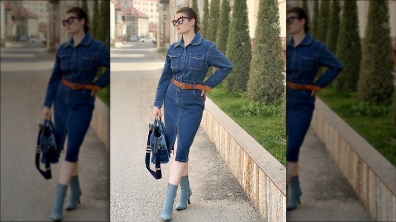 Woman wearing belted denim dress, boots