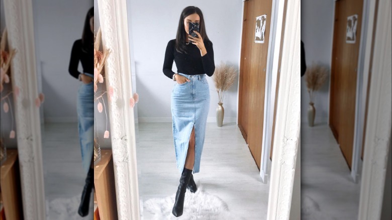 person in denim midi skirt