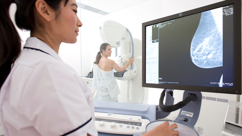 Technician examines mammogram image