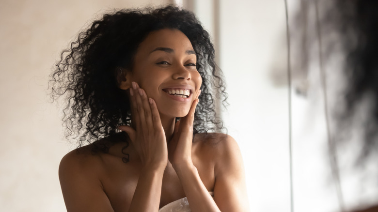 woman smiling in mirror